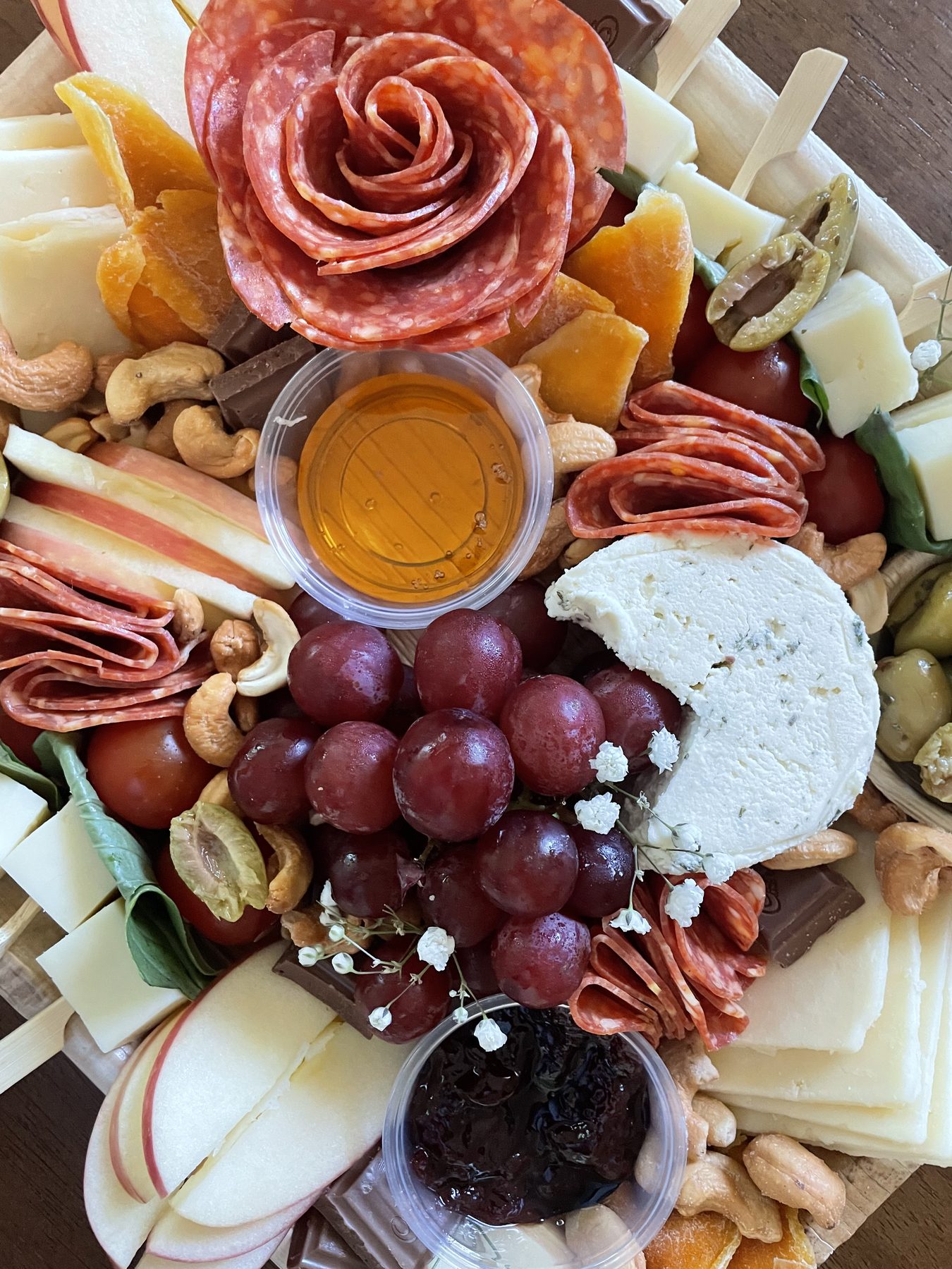 An abundant board with salami roses and flowers